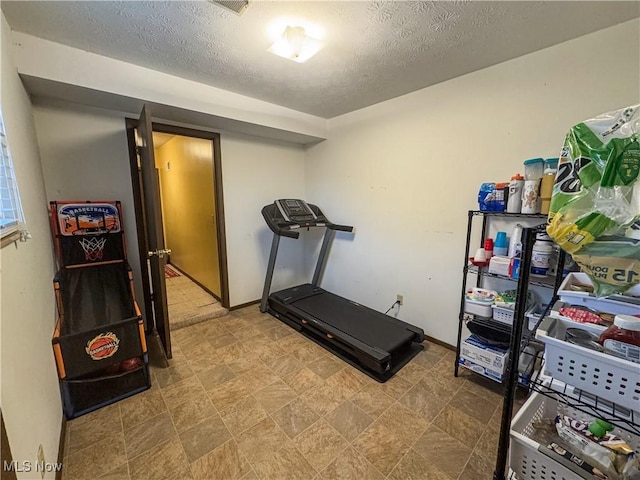 exercise area with a textured ceiling