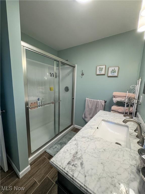 bathroom featuring vanity and a shower with shower door