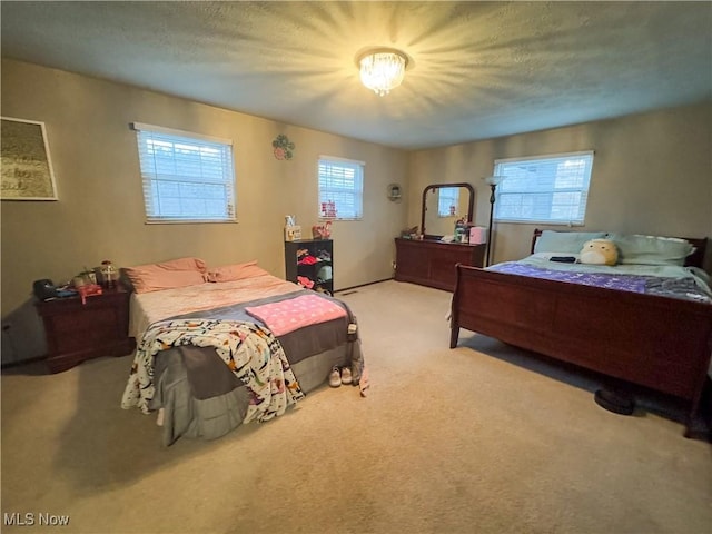 carpeted bedroom featuring a textured ceiling