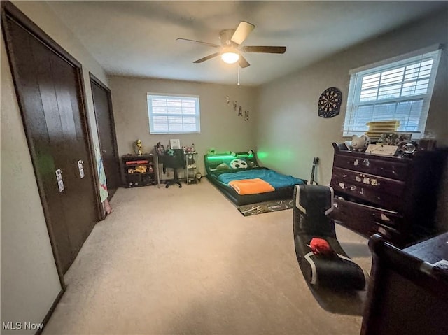 carpeted bedroom with ceiling fan