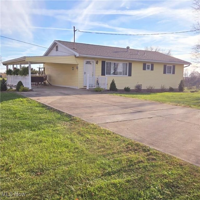 ranch-style house featuring a front yard and a carport