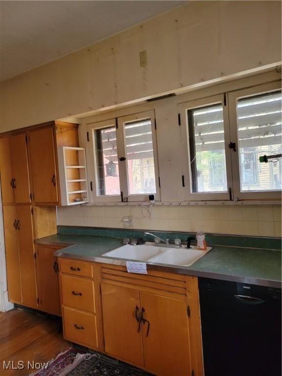 kitchen with decorative backsplash, black dishwasher, dark hardwood / wood-style floors, and sink