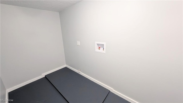 laundry room with washer hookup, gas dryer hookup, and a textured ceiling