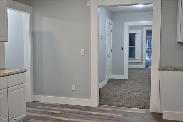 hall featuring carpet flooring