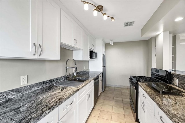 kitchen featuring black appliances, white cabinets, sink, and dark stone counters