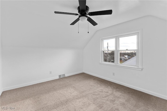 additional living space with ceiling fan, carpet floors, and vaulted ceiling