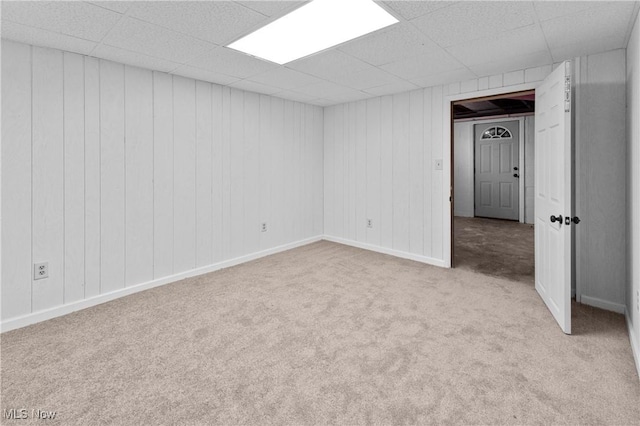 unfurnished room with a drop ceiling and light colored carpet