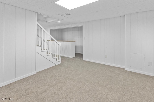 basement with carpet flooring and a paneled ceiling