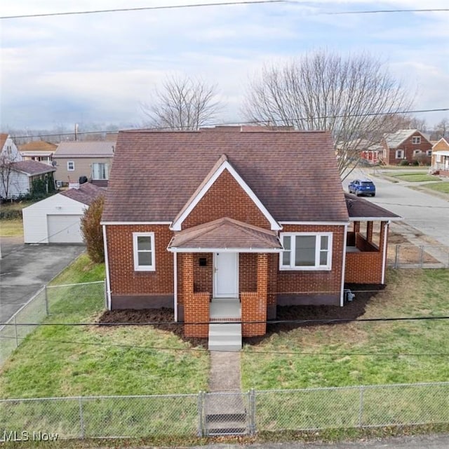 view of front facade featuring a front yard, an outbuilding, and a garage