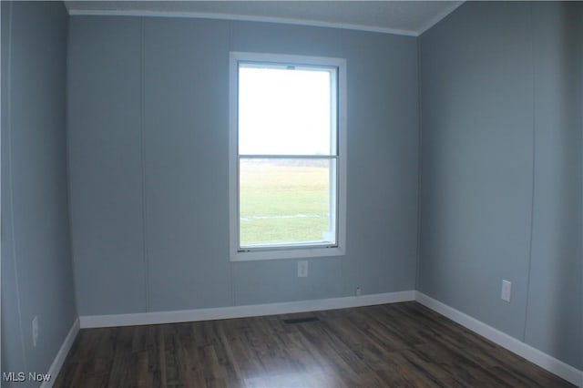 spare room featuring dark hardwood / wood-style flooring