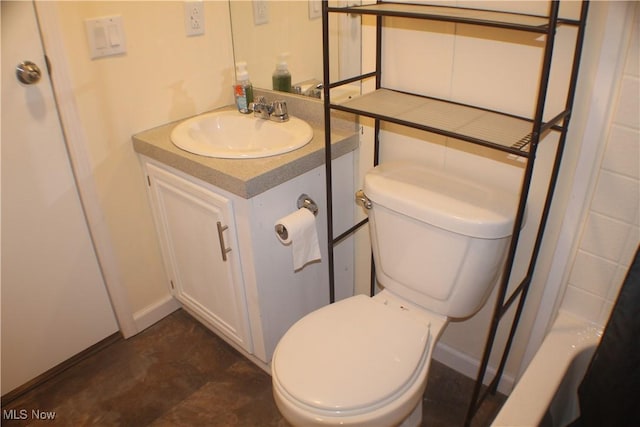 bathroom with vanity, toilet, and walk in shower