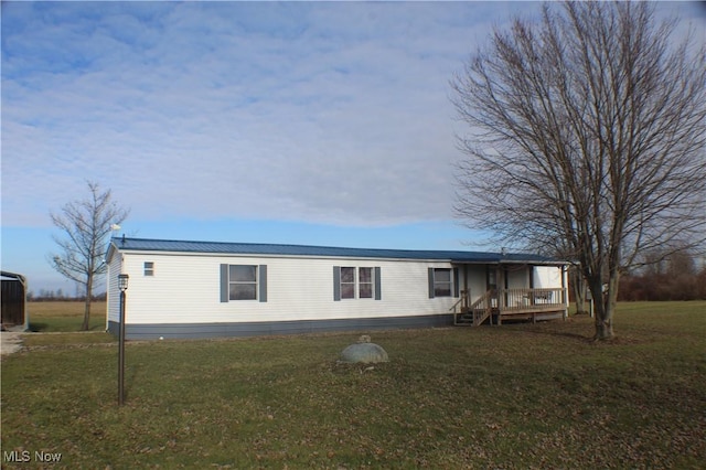 view of front of house with a front yard and a deck