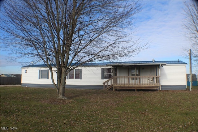 back of property featuring a lawn