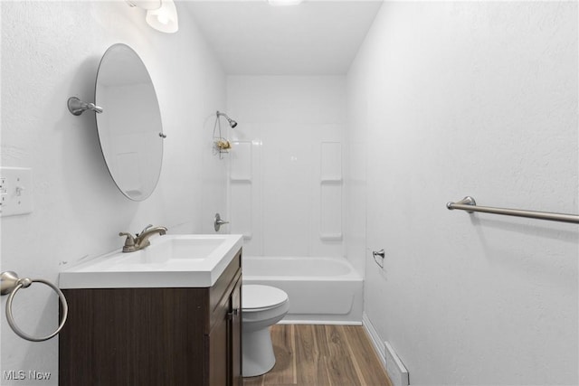 full bathroom featuring hardwood / wood-style floors, vanity, toilet, and  shower combination