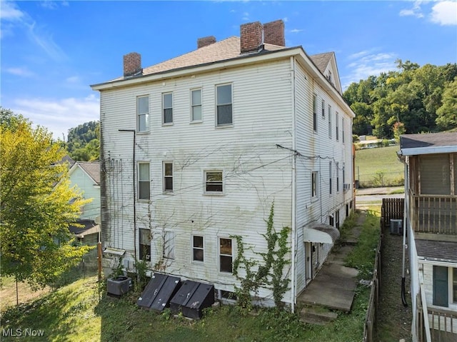 back of property featuring central AC