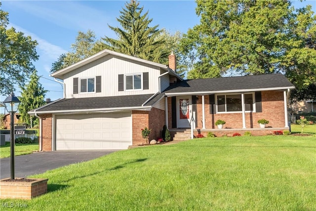 tri-level home featuring a garage and a front lawn