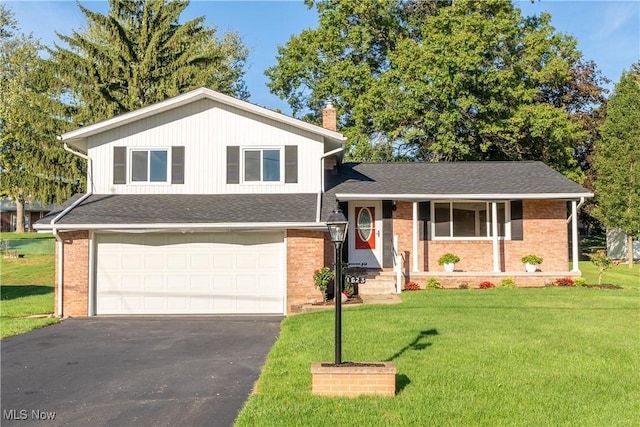 tri-level home with a garage and a front lawn