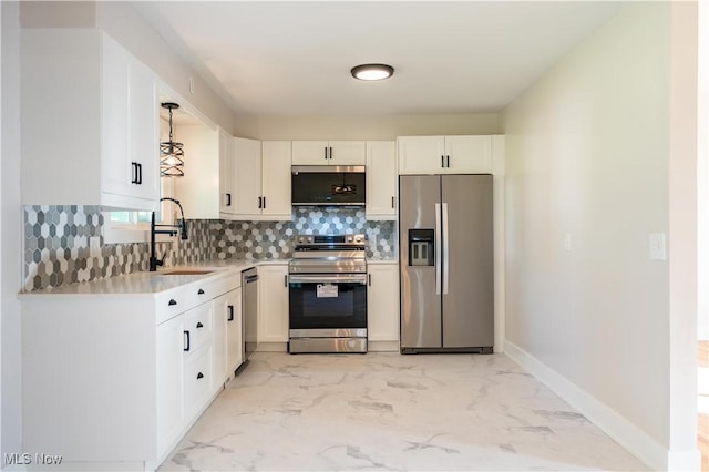 kitchen featuring white cabinets, sink, appliances with stainless steel finishes, and tasteful backsplash