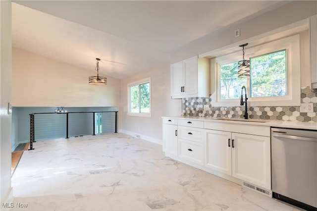 kitchen featuring white cabinetry, dishwasher, sink, backsplash, and lofted ceiling