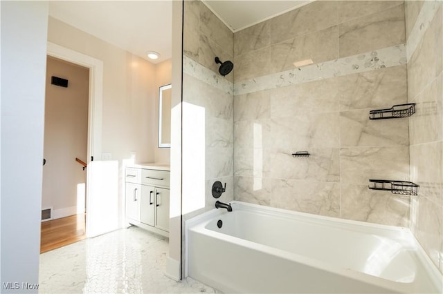 bathroom featuring vanity and tiled shower / bath combo