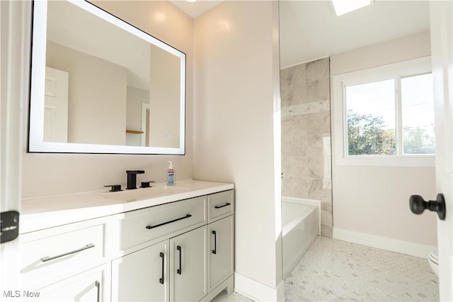 bathroom with vanity and tiled shower / bath