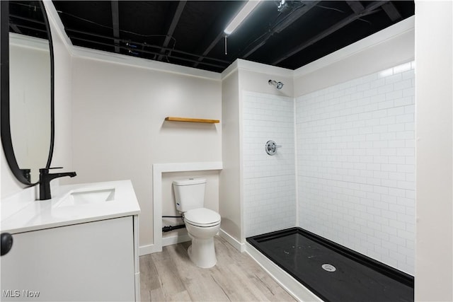 bathroom with vanity, hardwood / wood-style flooring, toilet, and walk in shower