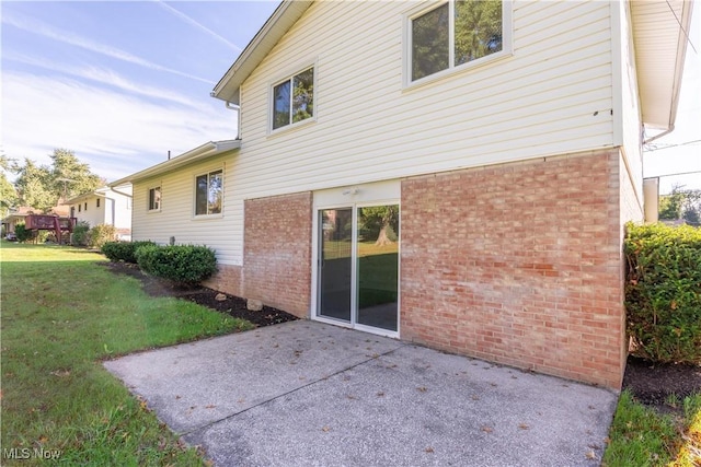 back of property featuring a lawn and a patio area