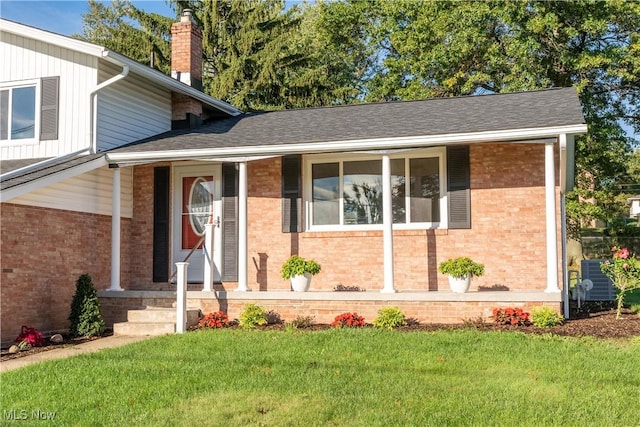 split level home with central AC and a front lawn