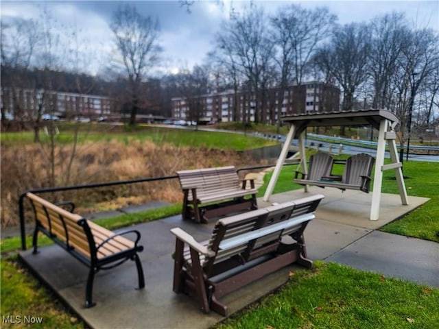 view of community featuring a yard and a patio area