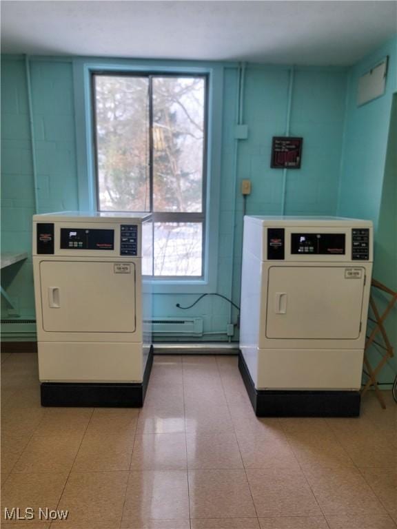 washroom with washer and dryer and a baseboard radiator