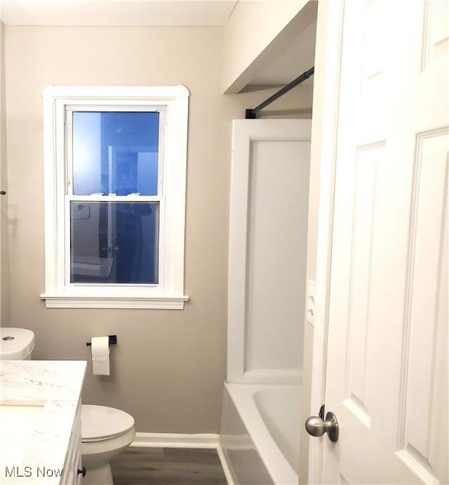 bathroom with hardwood / wood-style flooring, vanity, and toilet