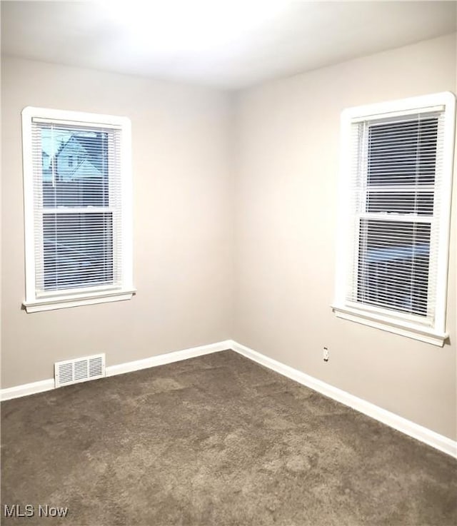 empty room with dark carpet