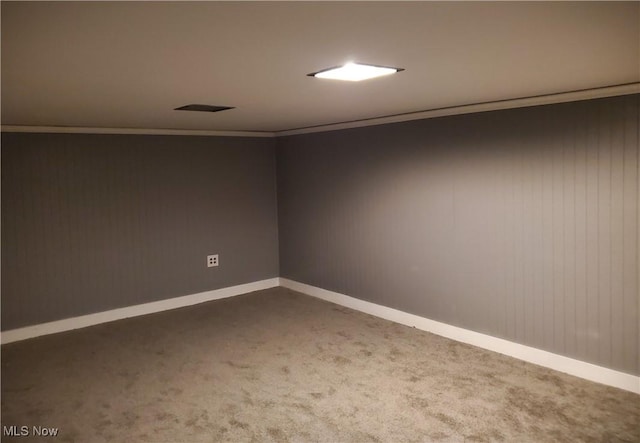 carpeted spare room featuring crown molding