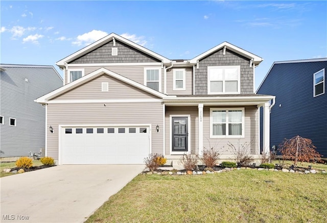 view of front of property with a front yard and a garage