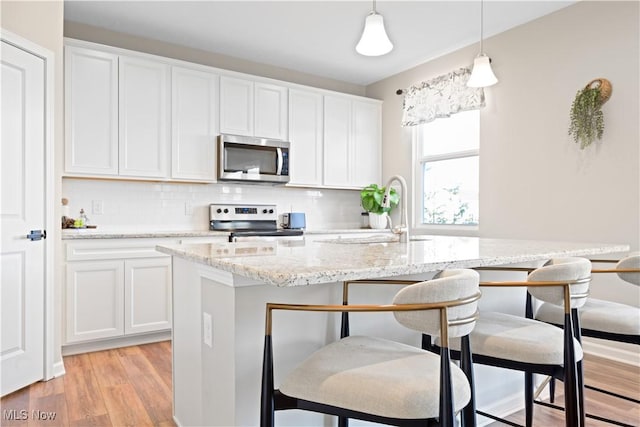 kitchen featuring white cabinetry, sink, and appliances with stainless steel finishes