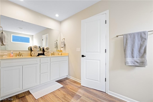 bathroom with vanity and wood-type flooring