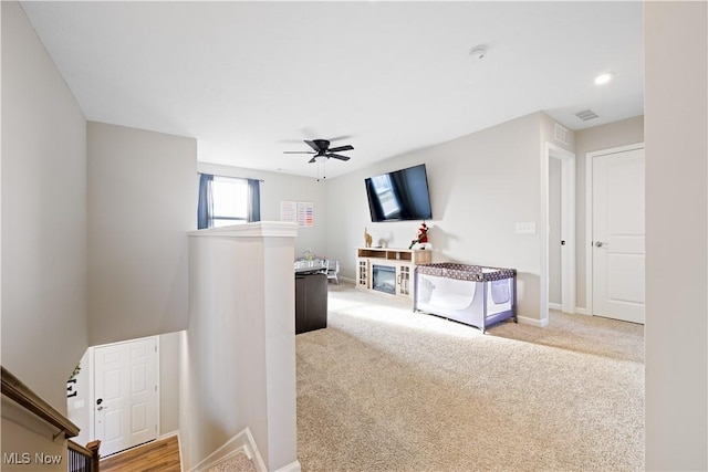 living room featuring light carpet and ceiling fan