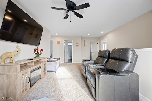 living room featuring light colored carpet and ceiling fan