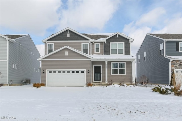 view of front of house with central AC and a garage