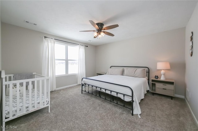 bedroom with baseboards, visible vents, ceiling fan, and carpet flooring