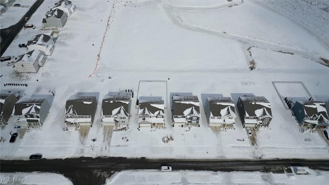 snowy aerial view featuring a residential view