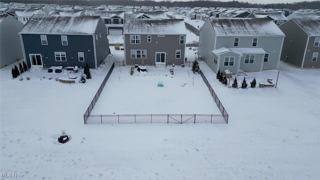 snowy aerial view featuring a residential view