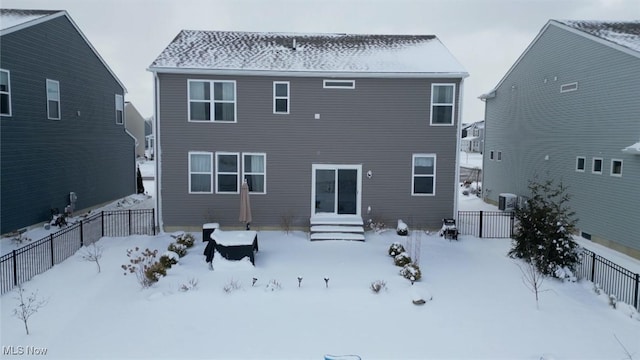 snow covered property featuring fence and entry steps