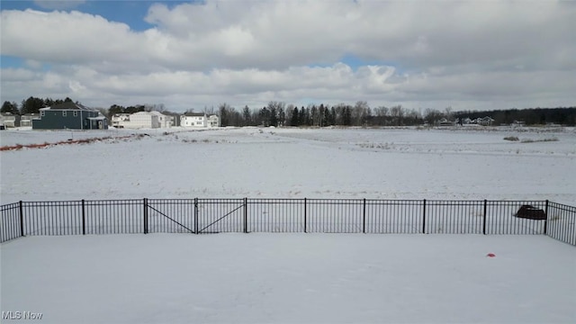 yard covered in snow with fence