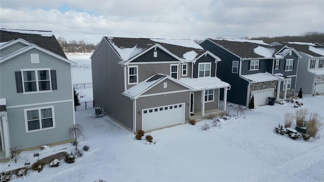 traditional home featuring a residential view, central air condition unit, and a garage