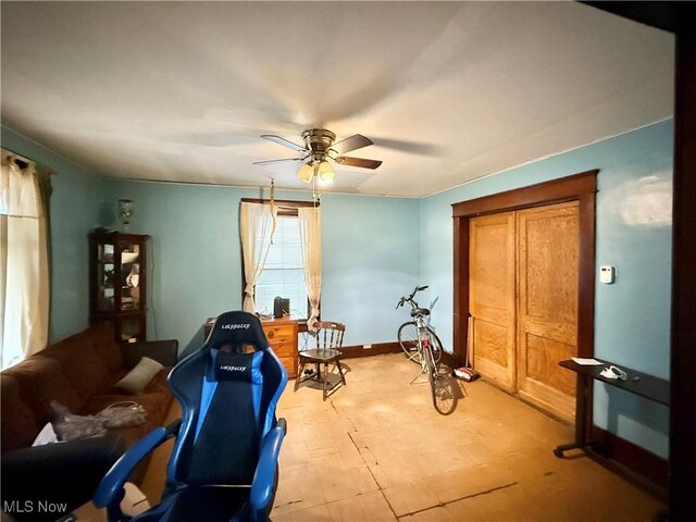 sitting room featuring ceiling fan