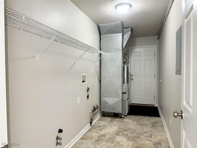 washroom featuring hookup for a washing machine and a textured ceiling