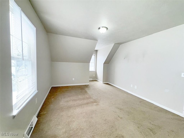 bonus room with carpet floors and vaulted ceiling