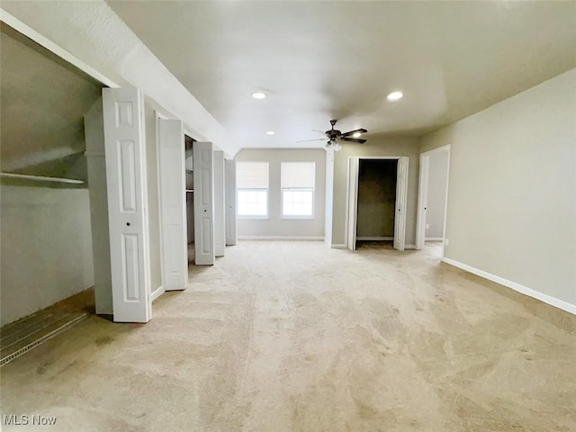 interior space with ceiling fan