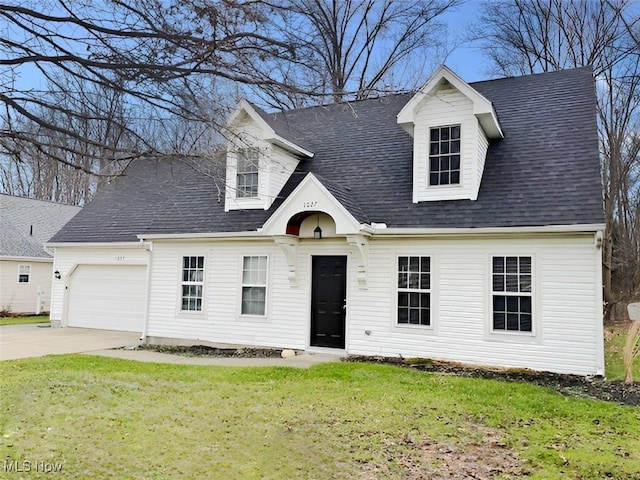 cape cod house featuring a front lawn and a garage